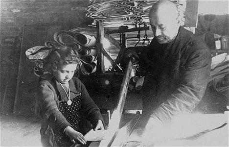 A young girl assists in the paper factory.