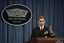 Pentagon Press Secretary Navy Rear Adm. John Kirby briefs reporters about current events, including the resignation of Defense Secretary Chuck Hagel, at the Pentagon 141125-D-DT527-036.jpg