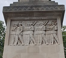 One of the relief carvings on the cenotaph, this one depicting a group of marching soldiers Portsmouth Guildhall Square WWI memorial, August 2020 05 (cropped).jpg