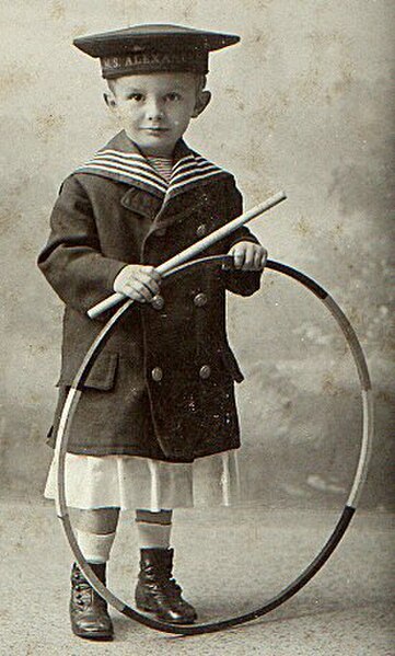 A boy with a hoop. Hoops have long been a popular toy across a variety of cultures.
