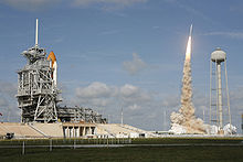 The Ares I-X test rocket lifts off from pad 39B while Atlantis waits to launch on STS 129 from pad 39A.