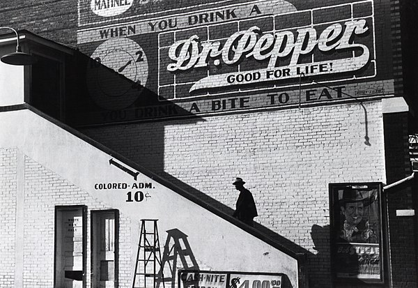 A black man goes into the "colored" entrance of a movie theater in Belzoni, Mississippi, 1939.