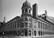 The signature corner tower in 1973. The damage from the 1971 fire can be seen. By then, the CONNIE MACK STADIUM metal plate had been removed, revealing the old SHIBE PARK name. The damaged area below it is where the cornerstone was located before being removed and sent to the National Baseball Hall of Fame and Museum where it sits today. ShibePark1973HABS1of9 (cropped).jpg