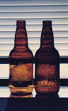 Two Sioux City Sarsaparilla bottles, in the style sold for decades, until the 2010s Sioux City sarsaparilla bottles.jpg