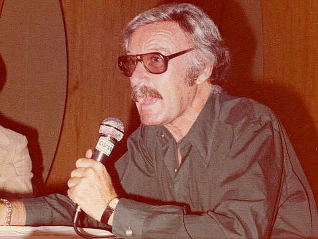 Lee speaking at a convention c. 1980