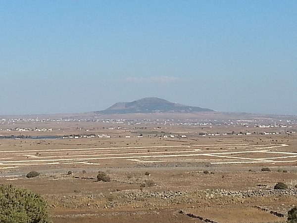 The Tell al-Hara volcanic cone in the Jaydur region of the Hauran plain, as seen from the Golan Heights to the west