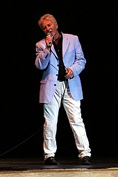 Tony Burrows, lead singer of Edison Lighthouse, who had the first new number-one single of the decade Tony Burrows Caravan XV 3777f.jpg