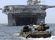 color photo of swimming AAVs approaching the well deck of an amphibious assault ship