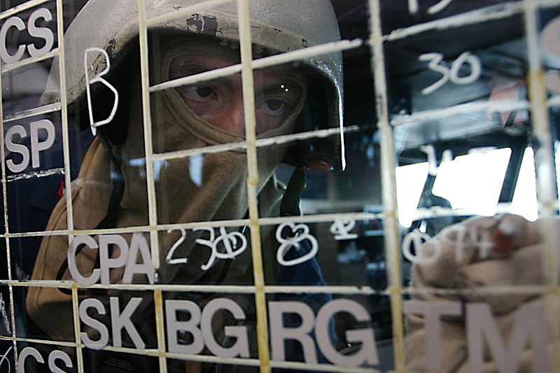 File:US Navy 061028-N-8591H-041 Operations Specialist 3rd Class Thomas Morales from Charlotte, N.C., updates a status board during a general quarters (GQ) drill on the bridge aboard USS Kitty Hawk (CV 63).jpg