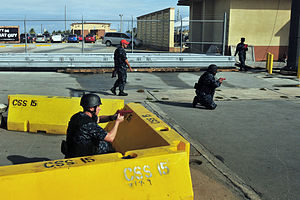 US Navy 120126-N-ET019-645 Sailors assigned to the submarine tender USS Emory S. Land (AS 39) cover the pier during an anti-terrorism force protect.jpg