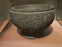 Basalt bowl with engraved inscription in Luwian hieroglyphics found in Babylon, southern Iraq in the 1880s and now in the collection of the British Museum Vase a piedestal neo-hittite, exposition Royaumes oublies, Louvre 2019.jpg