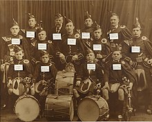 Early 1900's Worcester Kiltie Pipe Band. P/M Thomas Denholm can be seen in the top left. WKPB 1916.jpg