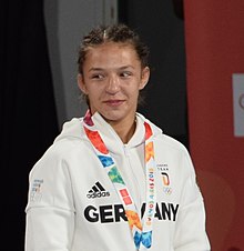 Women's Freestyle 57kg Wrestling Medallist Ceremony YOG1 13-10-2018 (08) (cropped).jpg