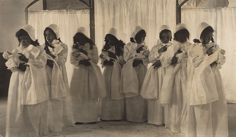 File:"Fort Spokane, Boarding School" Girls in pilgrim dresses, with dolls, presenting pageant. On back- "Left, Hildred Nee, 2nd from (5b8139ad-8953-4284-bc8a-c24affa5b934).jpg