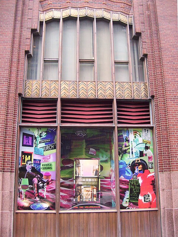 A storefront with a "curtain"-shaped opening on the second floor