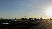 Thumbnail for File:Aeronaves no ponto de espera no Aeroclube de Bauru (SBBU), aguardando a autorização da torre de controle para a entrada na pista após a decolagem de outro avião. O aeroporto estava com tráfego - panoramio.jpg