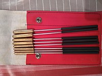 The triangle is struck with a metal rod called a "beater". Pictured are Chaklin brand metal beaters. Baquetes de triangle de la marca Chalklin.jpg