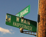 Bilingual street sign in Fredericksburg Texas.png