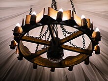 Wagon wheel chandelier Chandelier with candelabra in the Snow White cafe on the second floor in Andersengrad 2021.jpg