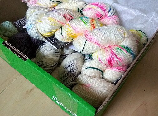 Colourful hand dyed wool in a green box