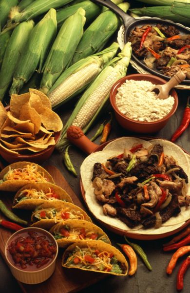 Examples of modern Tex-Mex dishes and ingredients: corn, tortilla chips, cheese, tacos, salsa, chilies, and beef dishes