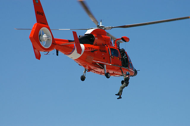 Members of USCG Air Station Savannah use a USCG HH-65C demonstrating a helicopter rescue.