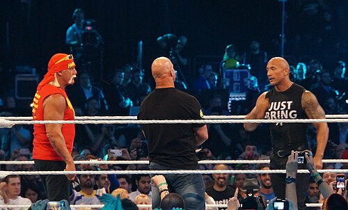 Austin (center) with Hulk Hogan (left) and The Rock at WrestleMania XXX