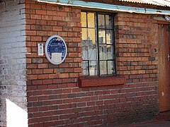 blue plaque on simple brick building