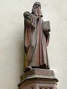 Johannes Oekolampad (1482–1531) theologian humanist, reformer from Basel.  Sculpture made of red sandstone, at Basel Minster