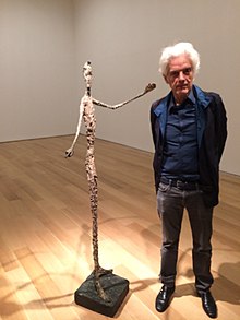 Photo of Judd Tully with the hand-painted Alberto Giacometti bronze, "Pointing Man" from 1947 at Christie's New York 2015.