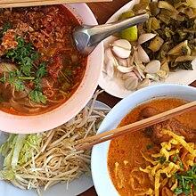 Two types of khao soi: top left is khao soi Mae Sai (with pork, no coconut milk), and bottom right is khao soi kai (chicken, with coconut milk). Khao soi 2 types.JPG