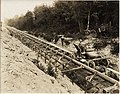 Men in concrete transport car on tracks over sewer construction, ca 1925 (MOHAI 4430).jpg
