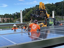 Solar installation, Newton North High School NNHS solar panels lift prep.agr.jpg