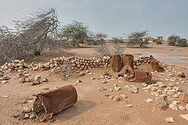 Remains of an oildrum fence for a farm in a depression in Ain Mohammed