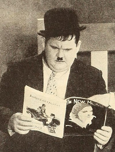 Oliver Hardy reading The New Movie.jpg