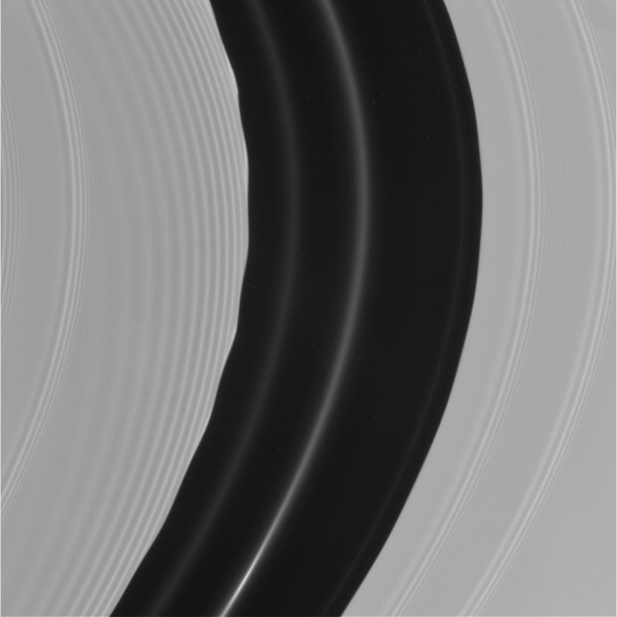 Pan's motion through the A ring's Encke Gap induces edge waves and (non-self-propagating) spiraling wakes[153] ahead of and inward of it. The other more tightly wound bands are spiral density waves.