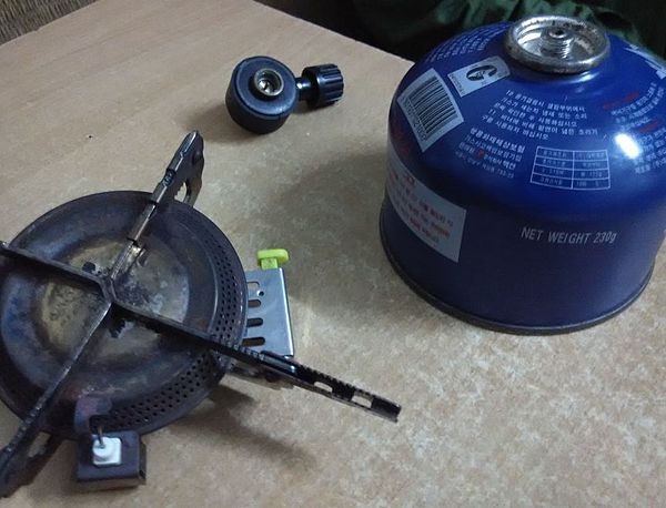 The parts of portable gas stove—gas cartridge, burner and regulator