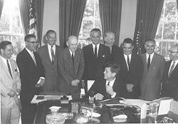 Growth of federal involvement in funding and administrating welfare began under President John F. Kennedy. President Kennedy signing the 1961 Amendments into law, June 30, 1961.jpg