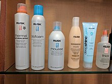 An assortment of Rusk-brand hair and beauty products on a store shelf. Rusk Products.jpg