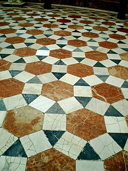A rhombitrihexagonal tiling: tiled floor in the Archeological Museum of Seville, Spain, using square, triangle and hexagon prototiles Semi-regular-floor-3464.JPG