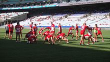 The Sydney Swans warm up before a match in 2013. Sydney Swans warming up 2013.jpg