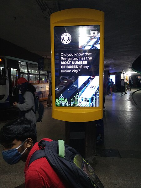 File:TV Screen at KempeGowda Bus Stand, Majestic Area, Bengaluru depicting Adverstiements and BMTC Bus Timings.jpg