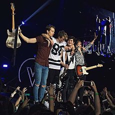 Color photograph of The Vamps on stage in April 2016