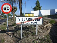 A simple identification sign attached to a town exit sign in Villarrubia de los Ojos, Ciudad Real, Spain Town Exit and Confirmation Sign.JPG