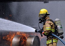 US Navy 080730-N-5277R-003 A Commander, Naval Forces Japan firefighter douses a fire on a dummy aircraft during the annual off-station mishap drill at Naval Support Facility Kamiseya.jpg