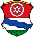 Gemeinde Faulbach Geteilt von Rot und Silber; oben ein sechsspeichiges goldenes Rad, unten über grünem Rasen ein blauer Schrägbach.