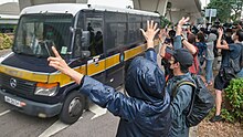 Supporters raise the five demands hand gesture outside West Kowloon Magistrates' Court when prison van carrying activists passes through them. West Kowloon Court outside car 20201123.jpg