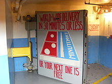 Minuteman Missile National Historic Site entrance door, satirizing the Domino's Pizza logo World-wide delivery in 30 minutes or less.JPG