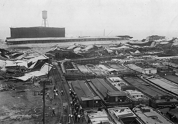 Wrecked warehouses and scattered debris after explosion.