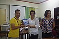 Michael Ong is given a copy of Dr. Sugbo's book.